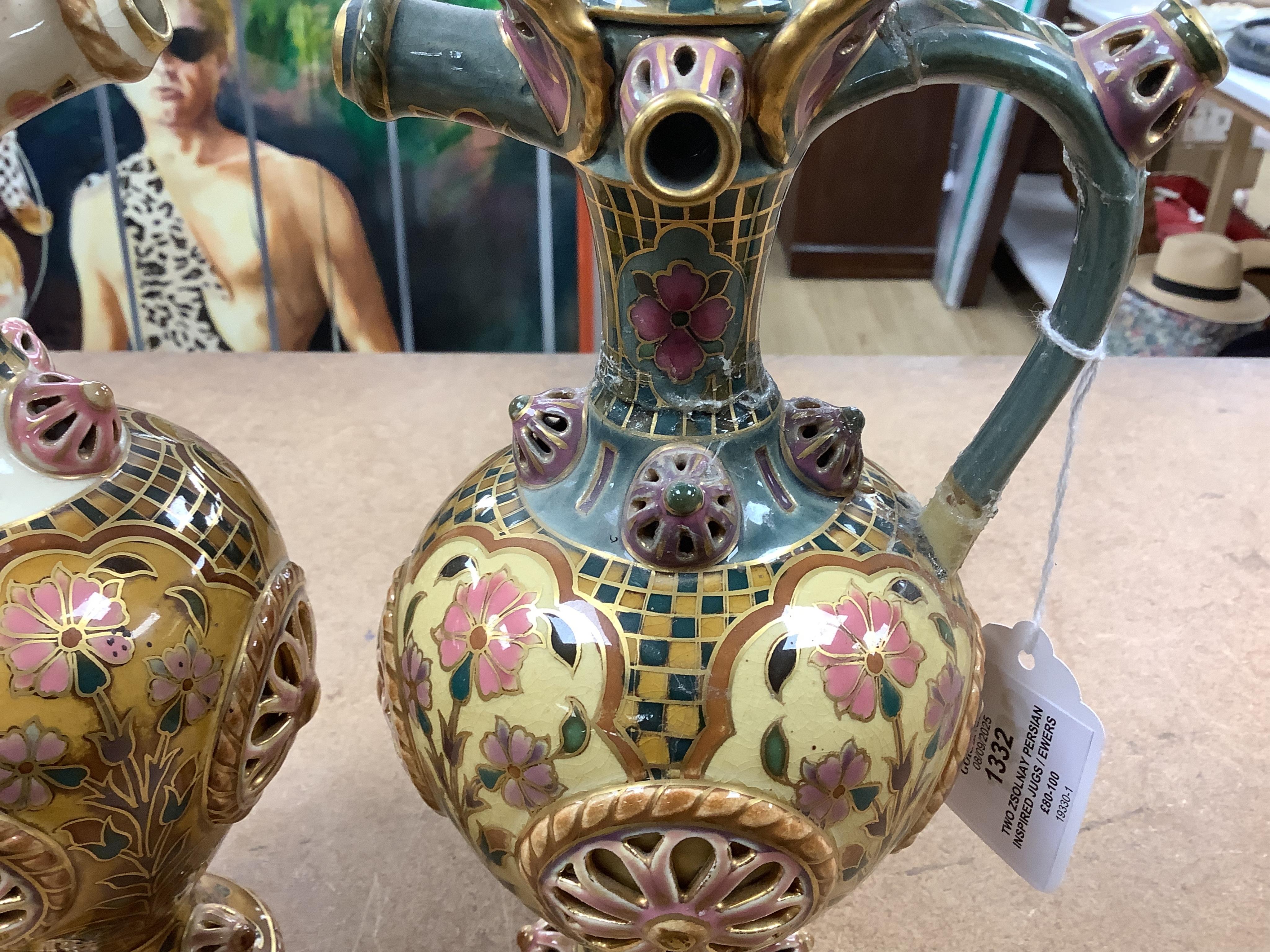Two Zsolnay Persian inspired jugs / ewers and covers, stamped to the bases 29cm high